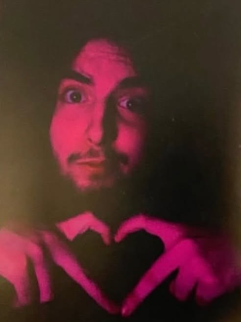 Young Sam holding a paper heart